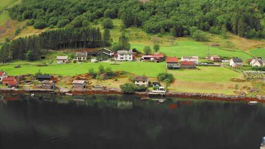 鸟瞰挪威巴卡的村庄。一个坐落在海岸上的小村庄。绿色农场