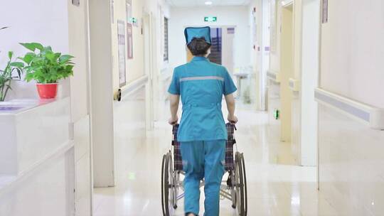 医院护士推着轮椅走在走廊
