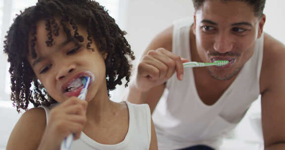 快乐的混血儿和他的儿子在浴室洗牙