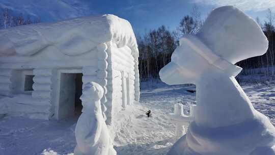 雪地中的雪雕小屋和动物造型