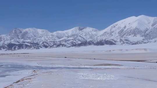 航拍新疆冬季赛里木湖冰封湖面雪山冰湖雪景