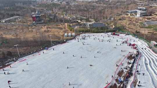 户外滑雪场中许多人在滑雪的热闹景象