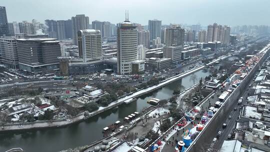 航拍陕西省西安市西安古城城楼大雪纷飞景观