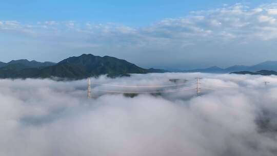 乡村高山顶云海中国家电网架输线路航拍压缆