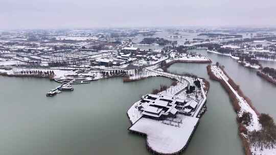 航拍湿地公园雪景树林湖岛木屋