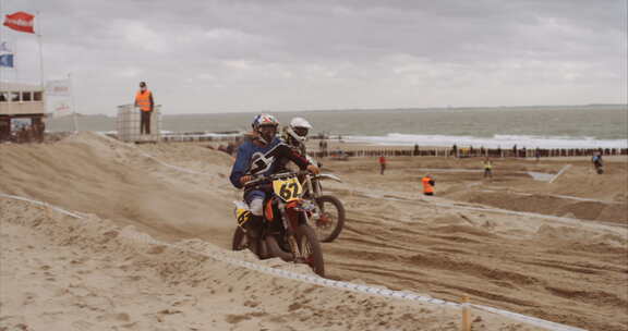 荷兰祖泰兰德海滩上的摩托车越野赛。慢动作手持拍摄。