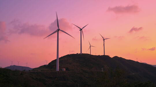 海岛晚霞中的风力发电机组