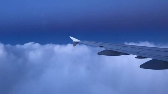 飞行在云层上空的飞机机翼