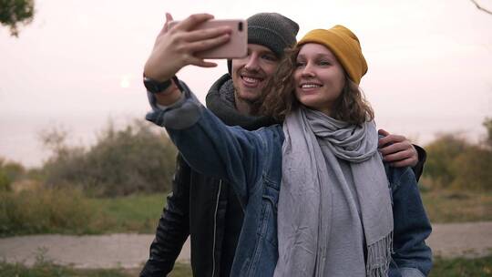在秋季公园用手机自拍的夫妇视频素材模板下载