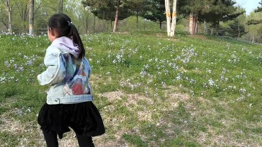 春天在开满野花的草地上奔跑的女孩