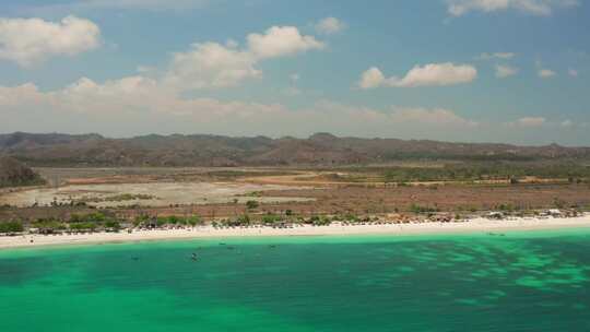 阳光明媚的一天，印度尼西亚龙目岛丹戎安的白色沙滩。航拍。