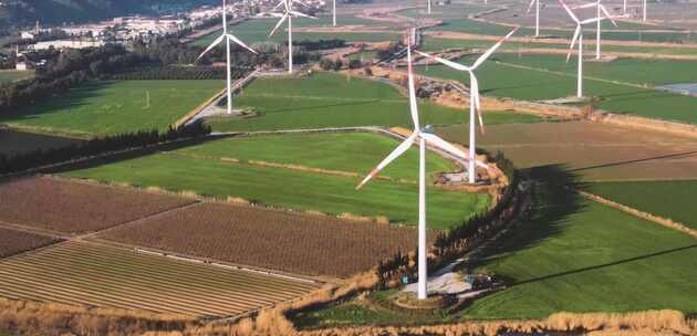 航拍农田里风力发电设备