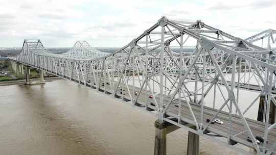 新月城市连接，汽车行驶在米河浑水上的双钢桁架悬臂桥上
