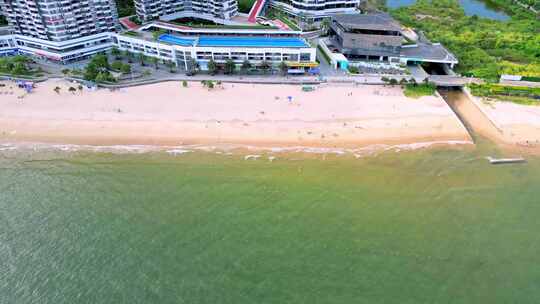 海滨城市高楼边的沙滩和海水景象