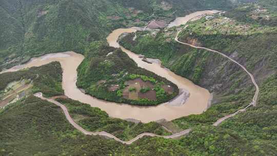 航拍山间河流蜿蜒公路盘旋的自然风光