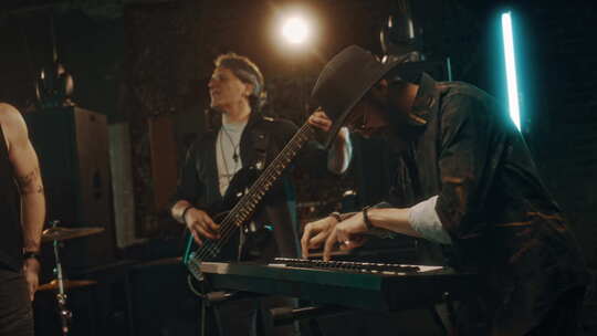 不同的男性音乐家在烟雾缭绕的工作室表演，