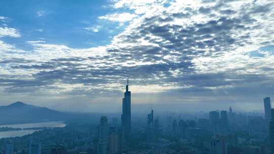 延时航拍南京地标紫峰大厦清晨光线穿透云层