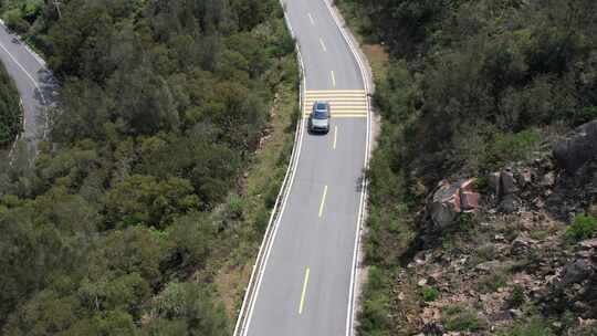 航拍跟随汽车行驶在山路上