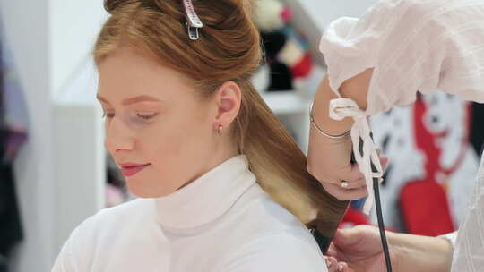 一个女人用卷发棒做头发的特写镜头