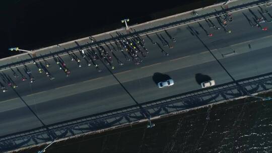 无人机拍摄。桥上马拉松跑步。俯视图