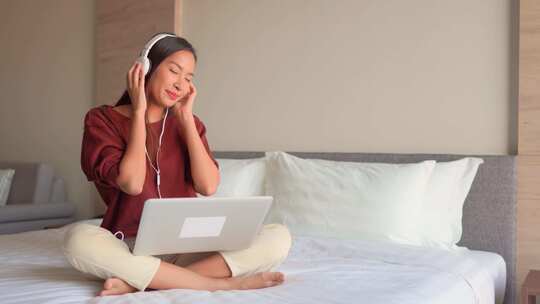 女孩坐在床上听音乐 慵懒女生视频素材模板下载