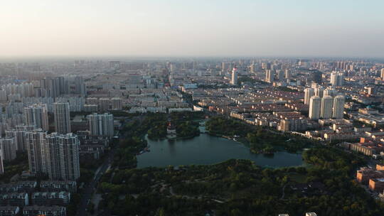 航拍山东济宁城市南池公园城市落日