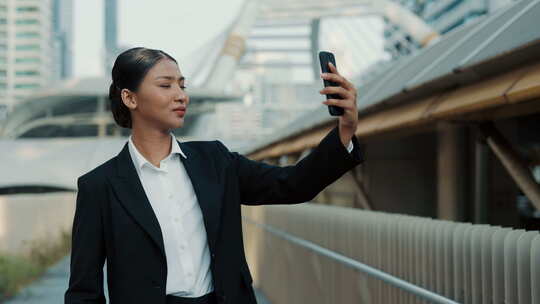 有魅力的女人站在外面，穿着办公服对着镜头