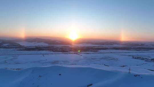 航拍寒冬雪域雪原灿烂夕阳