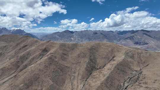 航拍西藏青藏高原蓝天白云下的高山景观