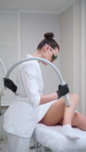 临床美容师的激光脱毛程序应用于客户的腿部