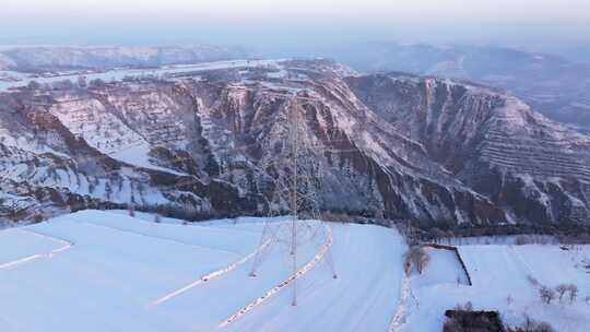 雪后山地风景及高压铁塔景象