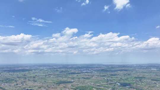 航拍蓝天白云云海平原乡镇延时空景