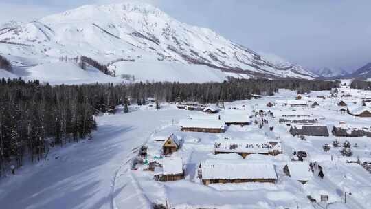 航拍新疆禾木雪景森林雪地小木屋禾木桥雪山