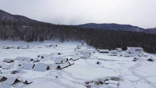 航拍新疆禾木雪景森林雪地小木屋禾木桥雪山