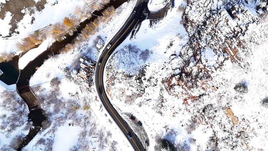 航拍高原雪山道路上行驶的汽车