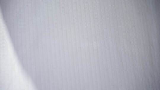风吹窗帘窗户白色窗帘飘动阳光透过白色窗帘