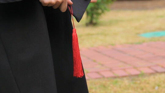 女士手持带流苏的毕业帽视频素材模板下载