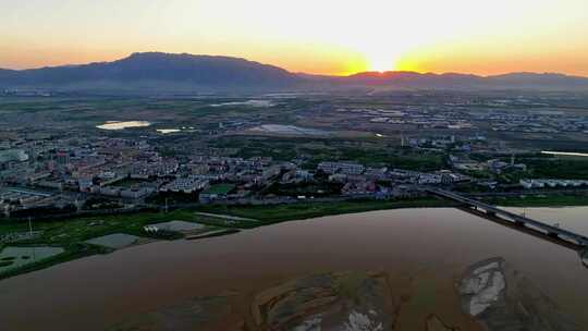 航拍夕阳下宁夏石嘴山惠农区城市风光