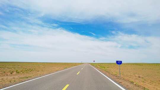 车辆行驶在新疆荒芜戈壁公路上窗外风景