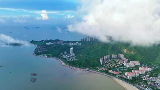 航拍大湾区空中透过云层看海边城市