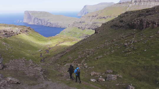 冒险家在Tjornuvik Faroe群岛沿着美丽的山路徒步旅行