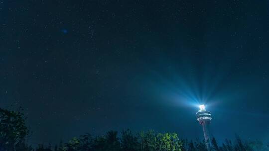 夜晚海港闪烁的灯塔海南木兰湾灯塔星空