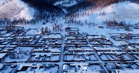 航拍兴安岭冬季日暮时分山村雪景