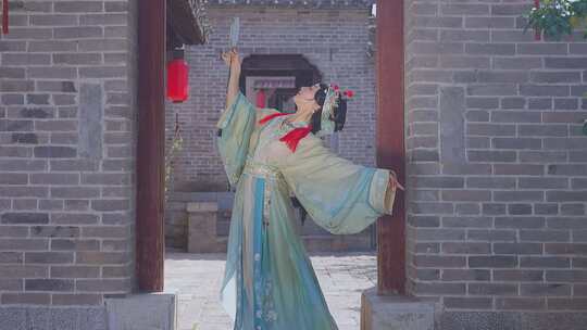 古风女子持镜古建筑前起舞