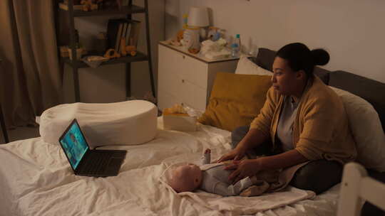 带着新生儿的西班牙裔母亲与儿科医生在线咨