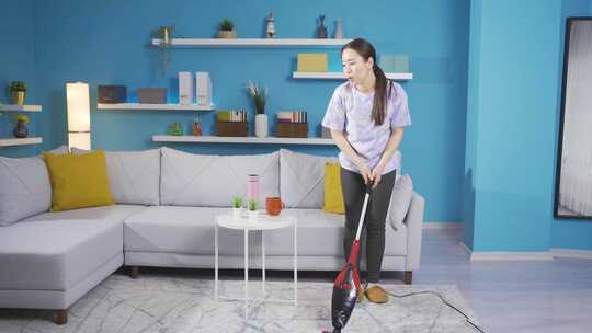 女人居家使用吸尘器清洁