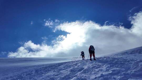 风雪中攀登慕士塔格雪山的登山者