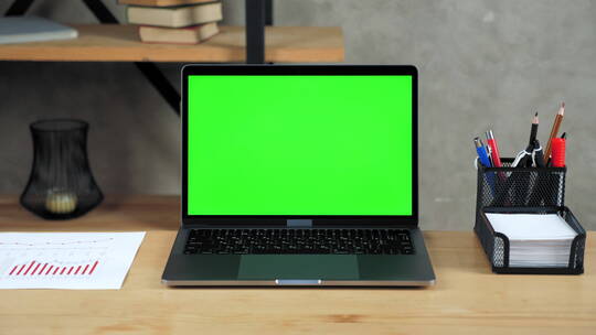 放在写字桌上的绿屏电脑视频素材模板下载