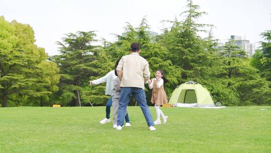 家庭出游一家人在公园露营玩游戏捉迷藏