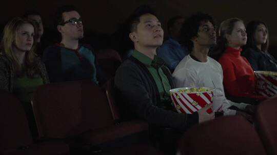 男人在电影院吃爆米花 视频素材模板下载